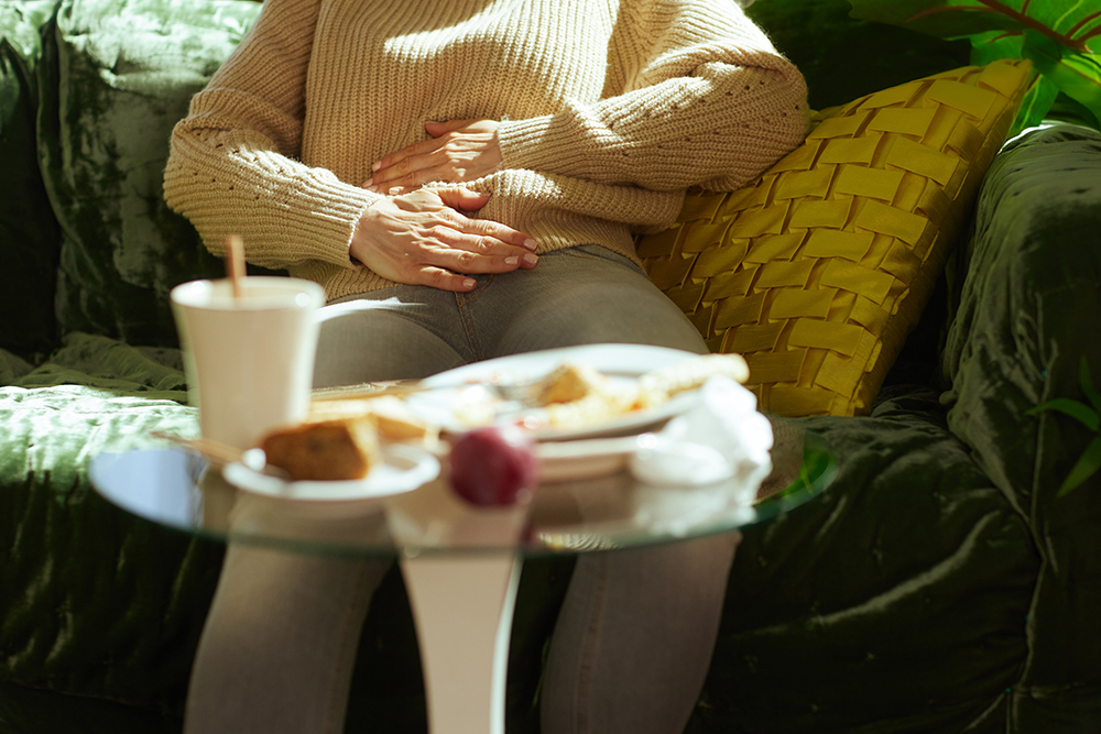 Adult Woman Suffering from Indigestion at Home